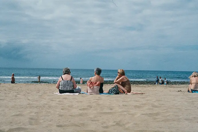 three women sitting on beach